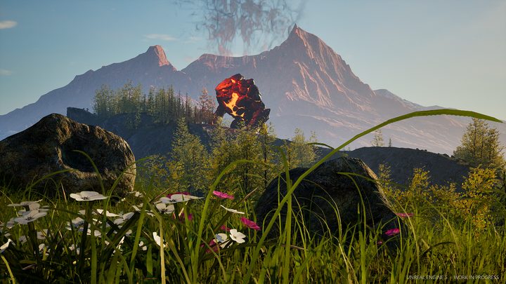 A fire creature beyond a green flowered meadow, mountains behind
